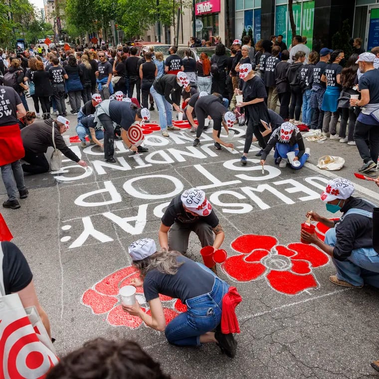 A message is painted on the street in front of Israeli Corporation for Israel that reads, “Jews Say: Stop Funding Genocide.”