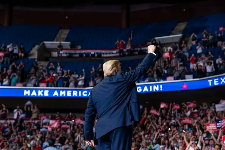 President Donald Trump arriving on stage to speak at a campaign rally at the BOK Center in Tulsa, Oklahoma on Saturday.