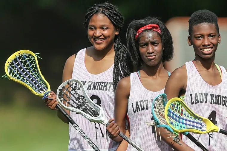 Strawberry Mansion’s lacrosse players, including Nadirah McRae, far right, when they were playing lacrosse their first season. Now, McRae is suing the school district.