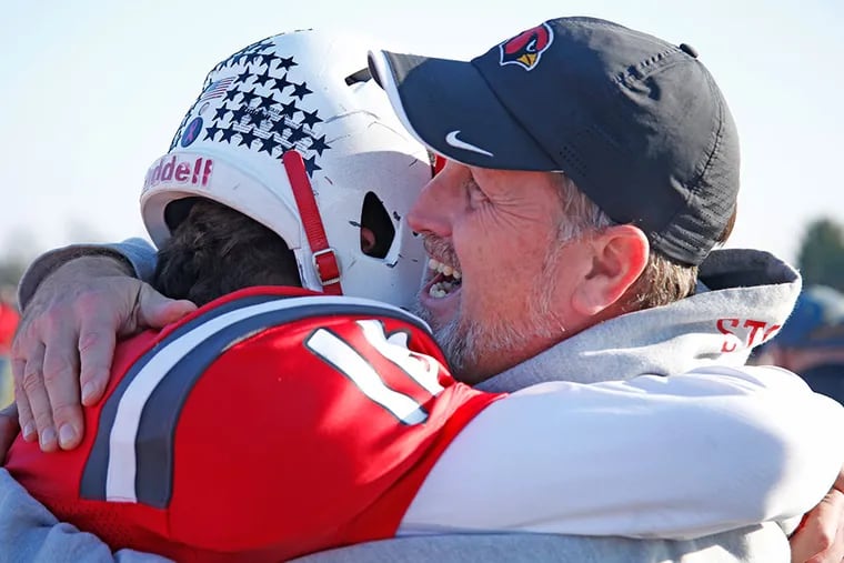 Upper Dublin coach Bret Stover is shown here hugging his son, quarterback Ryan Stover, in 2015. Upper Dublin, the District 1 champion, on Thursday forfeited the PIAA Class 5A state semifinal scheduled for Friday vs. Cathedral Prep.
