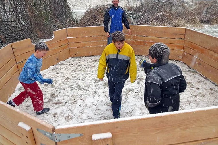 Hebrew School at Congregation Beth Israel teacher Alex Dresner plays with students in the snow inside their new gaga pit made from recycled wood. (Congregation Beth Israel Photo)