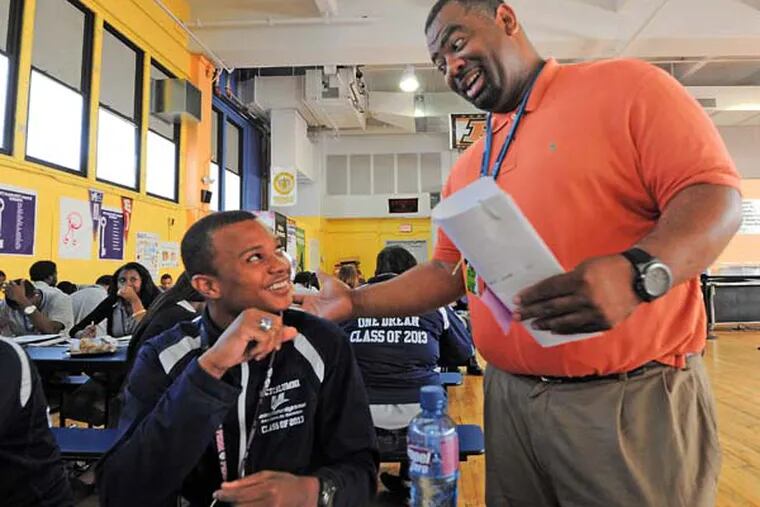 Mastery Thomas School in South Philadelphia on June 12, 3013.  Here, in the cafeteria, Dean of Students Dr. Tony Anderson talks to Kevin Beaford, 18, who has just become a Gates Milennium Scholar.  ( APRIL SAUL / Staff )