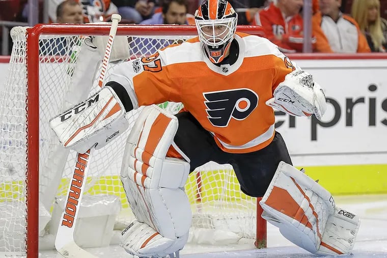 How long will Flyers goalie Brian Elliott be sidelined after core muscle surgery?