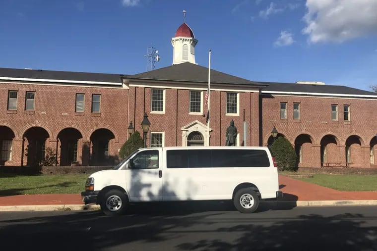 A van used to transport people to pick up messenger ballots is parked outside the Atlantic County courthouse.