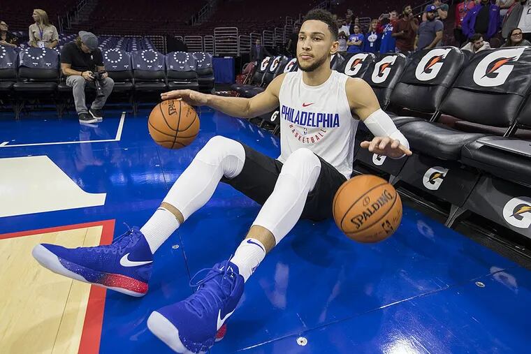 Ben Simmons warms up dribbling two basketballs before the preseason game Wednesday.