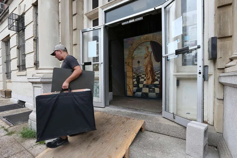 FILE - John Marino, of Broad Street Movers, carries items out of art studios at 915 Spring Garden St. in September 2015 after a small electrical fire led the city to shut down the building due to 29 code violations.