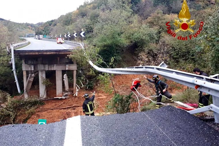Firefighters work in the area where a stretch of the Turin to Savona A6 highway collapsed following heavy rains. Rain-swollen rivers and flooded streets plagued Italy, where it has been raining, sometimes heavily, in much of the country nearly every day for about two weeks. Such events are becoming more common.
