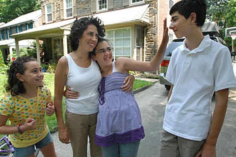Sam Slavitt takes the train into Center City; Sydney, left, and Shoshana walk to school in Merion Station. "The girls are fine," mother Nadine says. (April Saul / Staff)