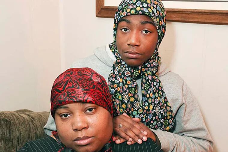 Tashiana Haggins-Montgomery and her daughter, Tashiyya Haggins, 14, at their home in Mayfair. They say that officer Tamika Gross brought her suspended 16-year-old daughter to school to fight and then jumped into the brawl when her daughter began losing.