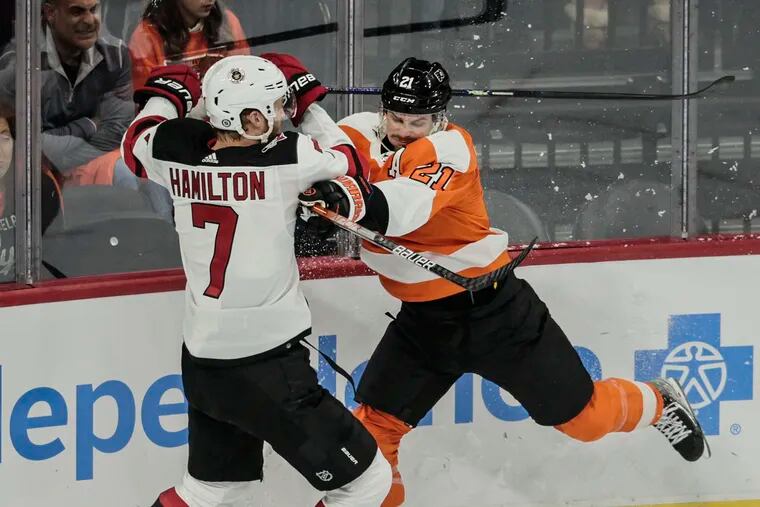 Flyers winger Scott Laughton checks Devils defenseman Dougie Hamilton during the first period on Thursday night. The Flyers outhit the Devils, 28-18, on the night.
