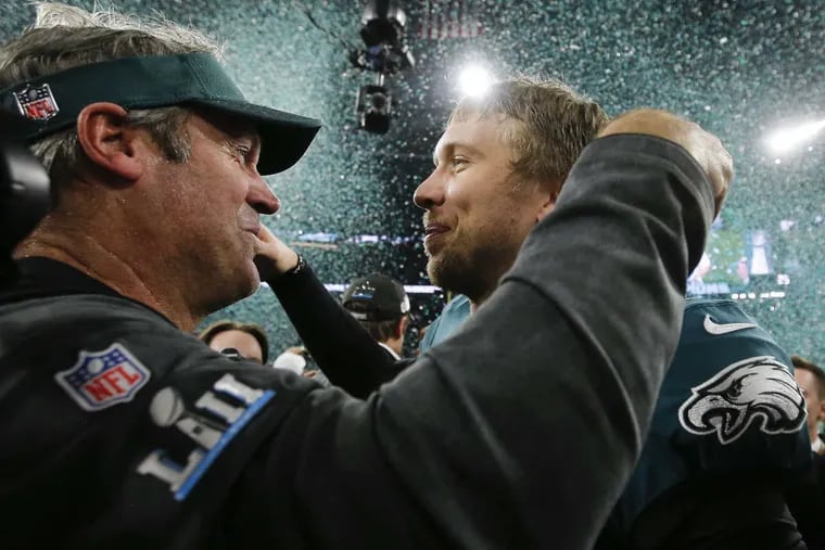 Eagles head coach Doug Pederson and Eagles quarterback Nick Foles celebrate after beating the New England Patriots in Super Bowl LII on Sunday, February 4, 2018, in Minneapolis.