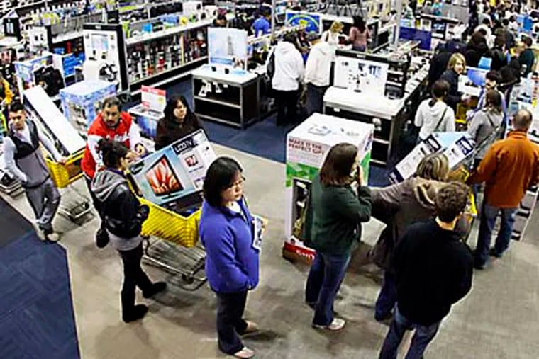 FILE-In this Friday, Nov. 25, 2011, file photo, a checkout line winds through a Best Buy store as shoppers take advantage of a midnight Black Friday sale on Friday, Nov. 25, 2011, in Brentwood, Tenn. The National Retail Federation, the nation's largest retail trade group, said Tuesday, Oct. 2, 2012, that it expects sales during the winter holiday shopping period in November and December to rise 4.1 percent this year. (AP Photo/Mark Humphrey, File)