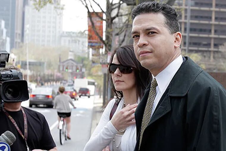A jury found former police inspector Daniel Castro (right, with unidentified woman) guilty in April of one count of lying to the FBI but deadlocked on 8 other counts. The jury also found him not guilty on one count of extortion. (David Maialetti / Staff Photographer)