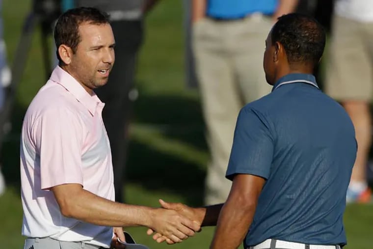 Sergio Garcia (left) shakes hands with Tiger Woods at the end of the third round of The Players championship golf tournament at TPC Sawgrass in Ponte Vedra Beach, Fla. Garcia apologized to Woods on Wednesday, May 22, 3013, for saying he would have "fried chicken" at dinner with his rival, a comment that Woods described as hurtful and inappropriate. (Gerald Herbert/AP)