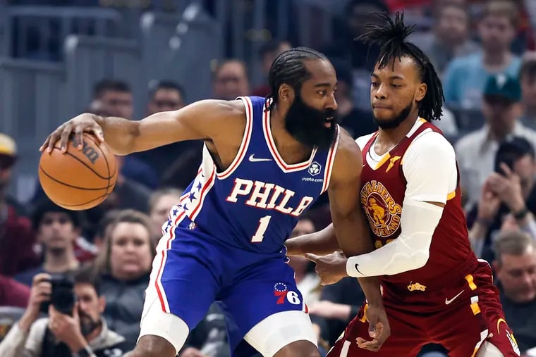 The  76ers' James Harden is guarded by Cleveland's Darius Garland during the first half.