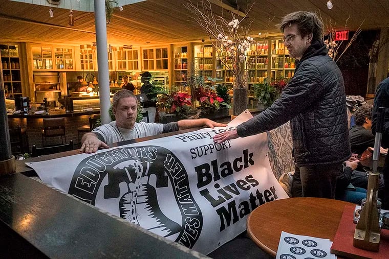 The Caucus of Working Educators held a happy hour at South Kitchen and Jazz Club Wednesday night, where interested teachers could pick up T-shirts, talk curriculum, plan events and mingle. Here, a Black Lives Matter banner is draped over a wall near the bar.