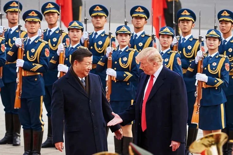 China's President Xi Jinping and U.S. President Donald Trump shake hands during a meeting outside the Great Hall of the People in Beijing in November 2017.