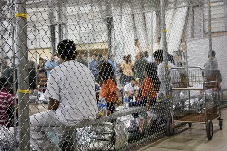 In this June 17, 2018 file photo provided by U.S. Customs and Border Protection, people who've been taken into custody related to cases of illegal entry into the United States, sit in one of the cages at a facility in McAllen, Texas. (U.S. Customs and Border Protection's Rio Grande Valley Sector via AP