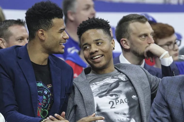 Sixers rookie Markelle Fultz (right) and guard Timothe Luwawu-Cabarrot talk on the bench during the Sixers’ win over the Nets on Friday.
