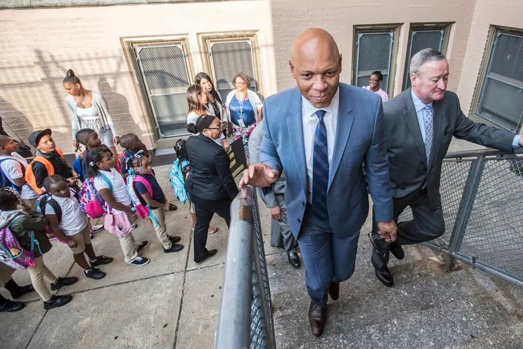 Philadelphia School Superintendent William Hite and Philadelphia Mayor Jim Kenney, right, climb the stairs into Pennell Elementary. Hite released his Action Plan 3.0 update Tuesday, claiming slow, steady progress.