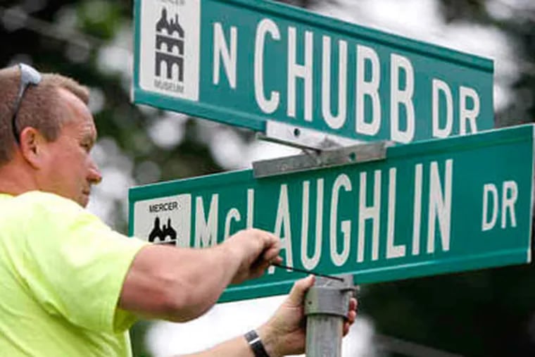 New street signs, at North Chubb and McLaughlin Drives, are put up by Doylestown employee Kevin Michener. Those roads, and nine more in the Maplewood area, are named for residents killed in World War II. (ELIZABETH ROBERTSON / Staff Photographer)