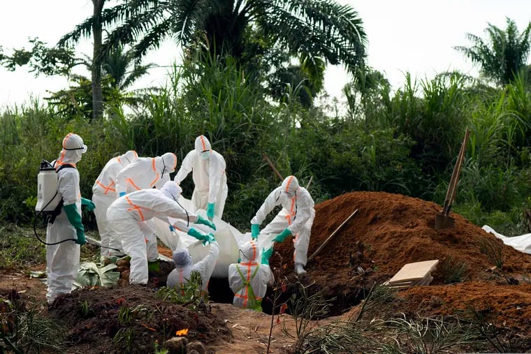 In this photograph taken Sunday July 14, 2019, an Ebola victim is put to rest at the Muslim cemetery in Beni, Congo DRC. The head of the World Health Organization is convening a meeting of experts Wednesday July 17, 2019 to decide whether the Ebola outbreak should be declared an international emergency after spreading to eastern Congo's biggest city, Goma, this week. More than 1,600 people in eastern Congo have died as the virus has spread in areas too dangerous for health teams to access.