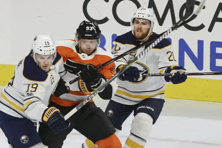 Jake Voracek, shown battling the Sabres’ Jake McCabe (19) and Scott Wilson (20) during a game last month, says the Flyers need to play with more of an edge in the season’s second half. Voracek leads the NHL with 43 assists.