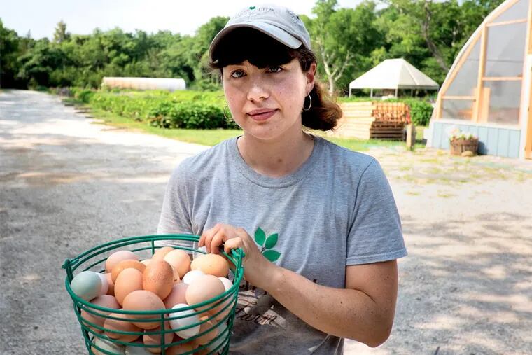 Shayla Groven, a recent graduate of Temple University, an a basket of fresh eggs at Beach Plum Farm in West Cape May.
