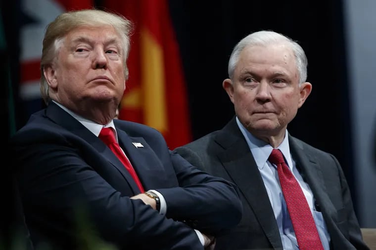 President Donald Trump, left, sits with Attorney General Jeff Sessions during the FBI National Academy graduation ceremony in Quantico, Va. on Dec. 15, 2017.