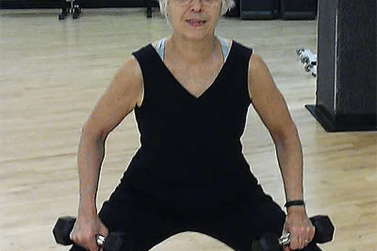 At the gym, Sue Edwards, 65, of Swarthmore, lifts weights to battle osteopenia. (Terry McClitis)