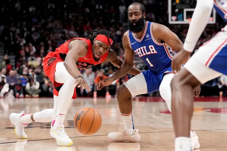 Toronto Raptors forward Precious Achiuwa (5) chases down a loose ball under pressure from Philadelphia 76ers guard James Harden (1) during first half NBA basketball action in Toronto, Thursday, April 7, 2022. THE CANADIAN PRESS/Frank Gunn