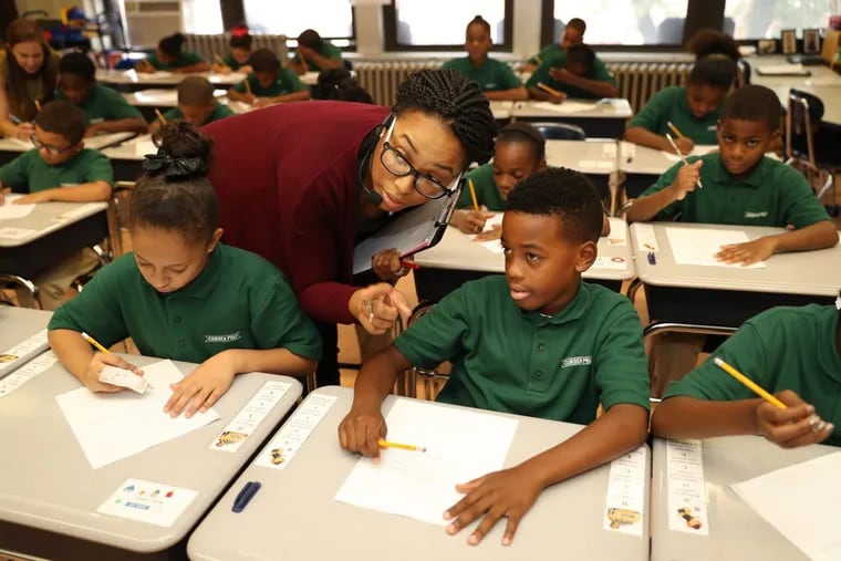 Fourth-grade teacher Alicia Montague-Keels helps Amir Goldston (right), 10, during a class math assignment at Camden Prep Academy, the old Bonsall Elementary School, on Wednesday, September 21, 2016.