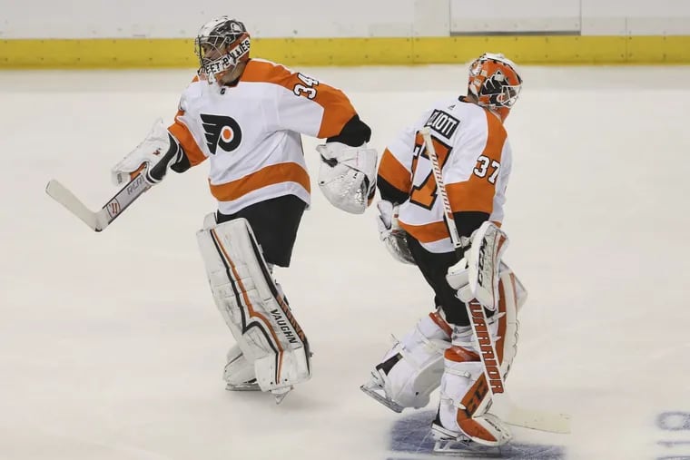 Flyers goalie Brian Elliott leaves, replaced by Petr Mrazek (left), in the second period of Game 1.
