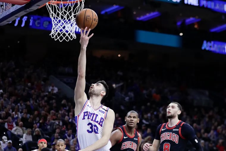 Sixers guard Furkan Korkmaz lays up the all past Chicago Bulls forward Cristiano Felicio (center) and guard Zach LaVine during the first quarter.