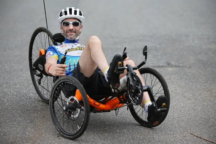 Kyle Bryant poses for a portrait on the trail behind his home in Exton, Pa., on Friday, April 19, 2019. Bryant, who has Friedreich's ataxia, a neurodegenerative movement disorder, wrote a book called "Shifting Into High Gear" about his cross-country journey in a recumbent tricycle.