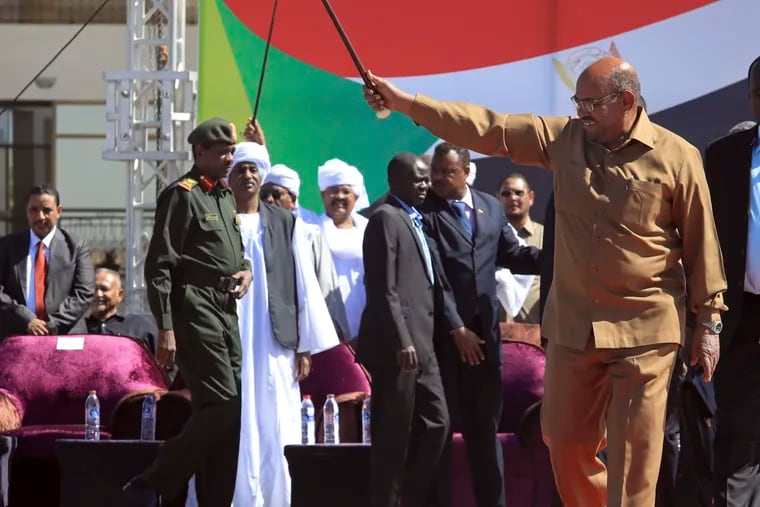 Sudan’s President Omar al-Bashir greets his supporters at a rally in Khartoum, Sudan, Wednesday, Jan. 9, 2019. Al-Bashir told the gathering of several thousands of supporters in the capital that he is ready to step down only “through election.” The remarks come after three weeks of anti-government protests. (AP Photo/Mahmoud Hjaj)