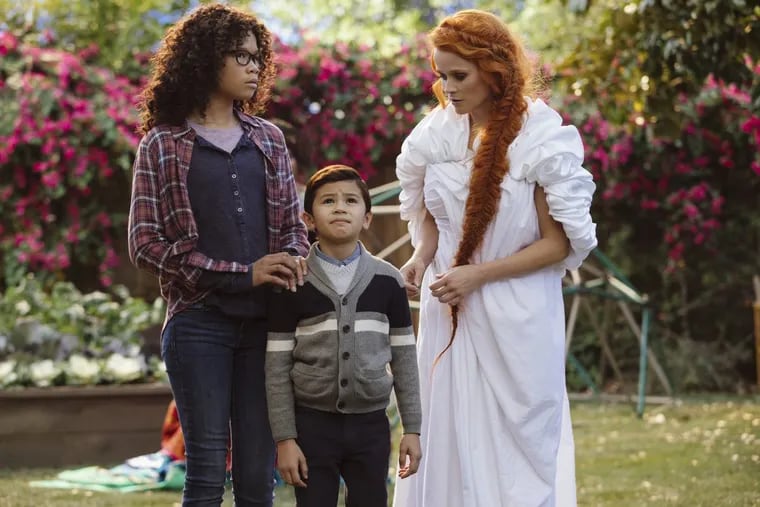 Storm Reid, (Meg) Deric McCabe (Charles Wallace) and Reese Witherspoon (Mrs. Whatsit)  in a scene from A Wrinkle In Time.