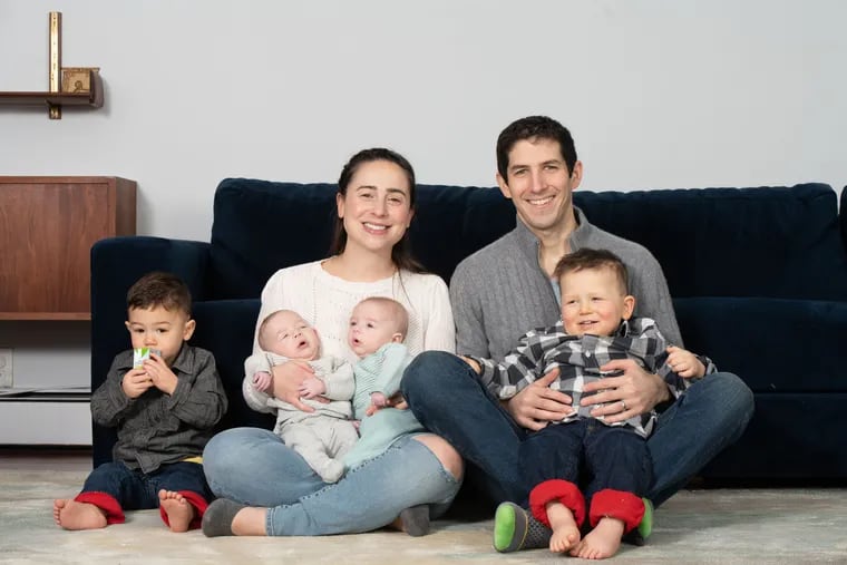 Rachel Krieger with her husband Max and children, including twins born in November. Miles and Levi have to stay on formula until they are one year old, but the shortages have caused Enfamil to cancel their standing order. Credit: Julia Lehman Photography