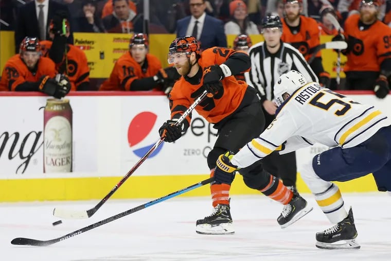 The Buffalo Sabres' Rasmus Ristolainen (55) defending against the Flyers' Claude Giroux in a 2019 game. The two are now Flyers teammates.