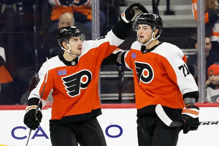 Flyers right wing Tyson Foerster (right) celebrates a goal with teammate Morgan Frost. Foerster is hopeful he can return on Saturday against the Rangers.