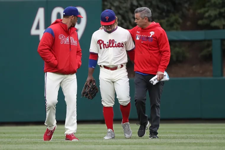 Phillies center fielder Odubel Herrera, center, had to leave last Wednesday's game with a strained right hamstring.