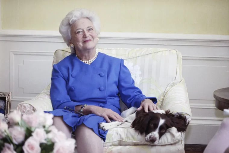 Barbara Bush, posing for  a 1990 photograph, wrote a popular book about her dog titled “Millie’s Book.”