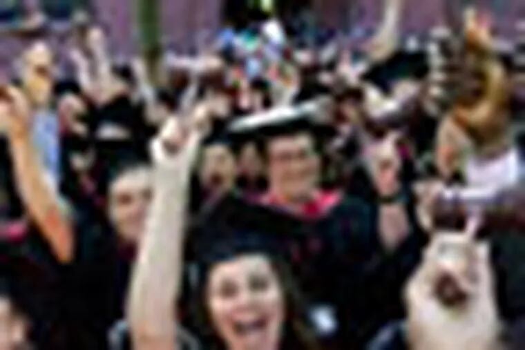 Graduates of Harvard Law School, including Daniela Martinez, of Santiago, Chile, front, wave gavels as their degrees are conferred during Harvard University commencement exercises, in Cambridge, Mass., Thursday, May 24, 2012. (AP Photo/Steven Senne)