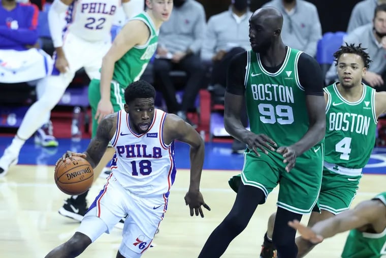 Shake Milton, left, of the SIxers drives around Tacko Fall of the Celtics during the second half of Tuesday's NBA preseason game.