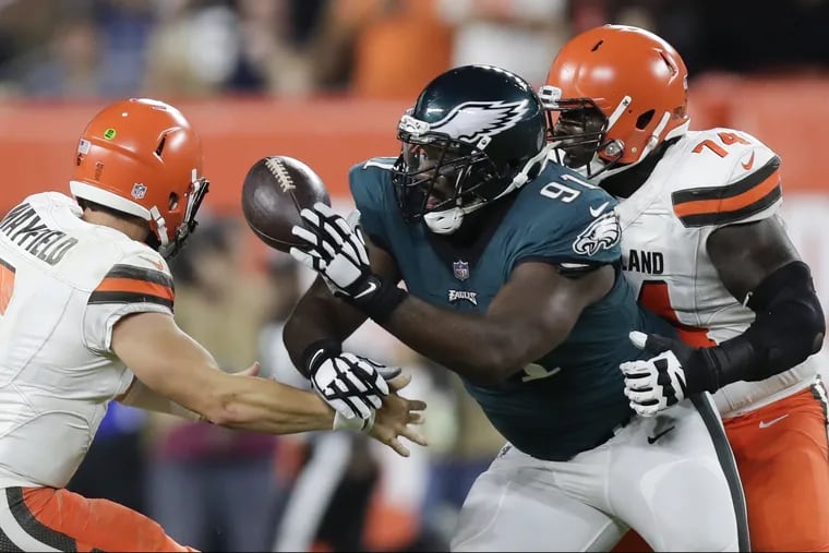 Philadelphia Eagles defensive end Fletcher Cox knocks the football away from Cleveland Browns quarterback Baker Mayfield past offensive guard Chris Hubbard during the first quarter of Thursday's preseason game.