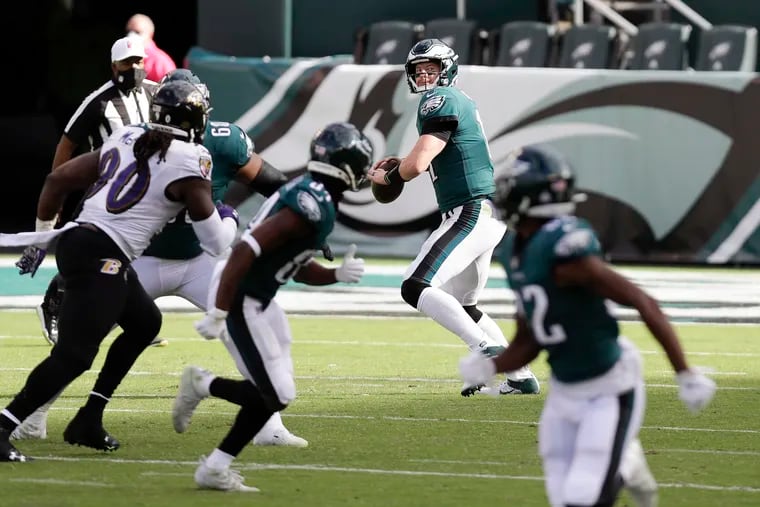 Eagles quarterback Carson Wentz looks for receivers against the Ravens on Sunday.