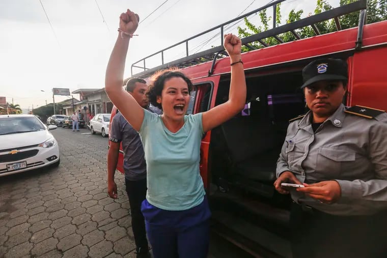Opposition member María Adilia Peralta Cerratos raises her arms in jubilation as she returns home after being in prison, in Masaya, Nicaragua, Monday, May 20, 2019.