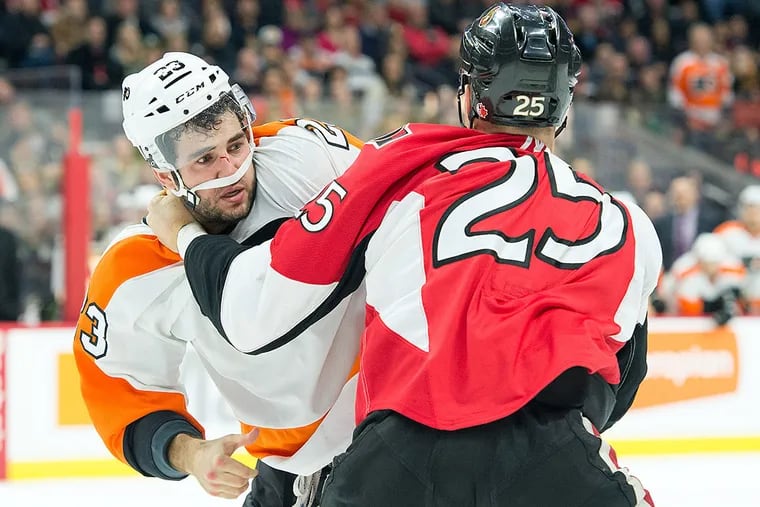 Philadelphia Flyers defenseman Brandon Manning (23) fights with Ottawa Senators right wing Chris Neil (25) in the second period at Canadian Tire Centre.