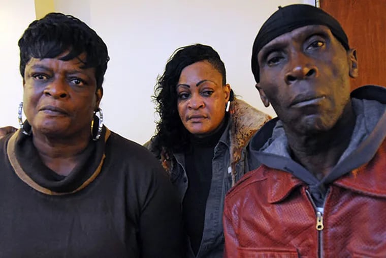 The family of Tiombe Carlos, who killed herself in custody in York County Prison, at the office of their lawyer, Tom Griffin, on Nov. 8, 2013.  Here, Tiombe's parents, Angela, left; and Hueth Carlos, right. TImobe's sister, Renee Benjamin, is in the middle.  ( APRIL SAUL / Staff )
