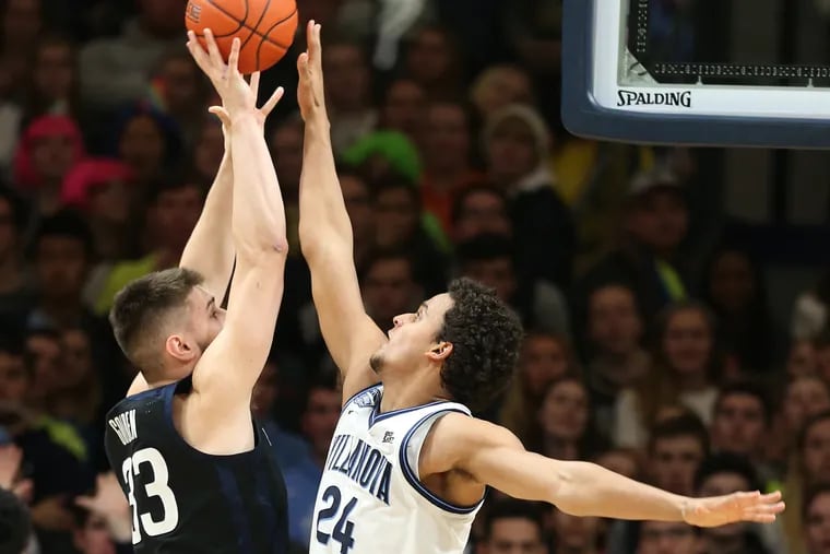 Jeremiah Robinson-Earl, right, of Villanova tries to block a shot by Bryce Golden of Butler last January at Finneran Pavilion. The two teams meet again Wednesday night at the same venue, but with no fans in attendance.